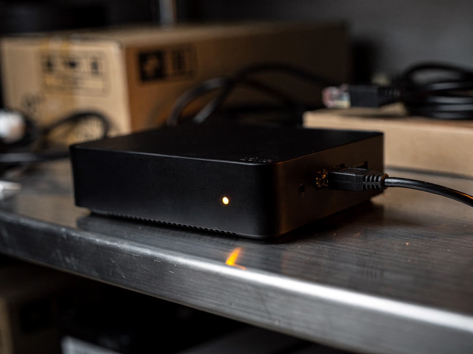 The Retail Theft box: a small black unit with an amber status light, on a shelf in a store back office